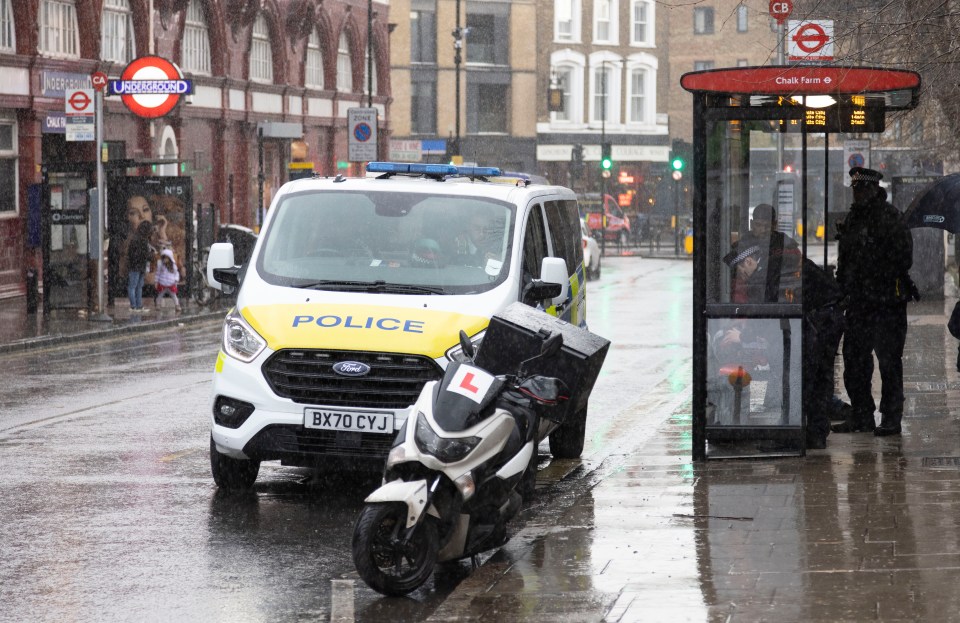 Police talk to a man in Primrose Hill, near Chalk Farm underground station