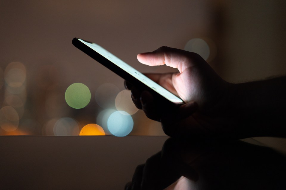 Detail of teenagers watching with their mobile phones