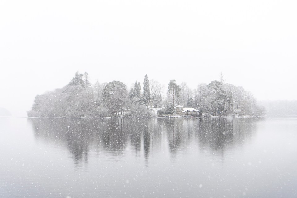 Kayakers head out on Derwentwater, Keswick, in a heavy snow blizzard