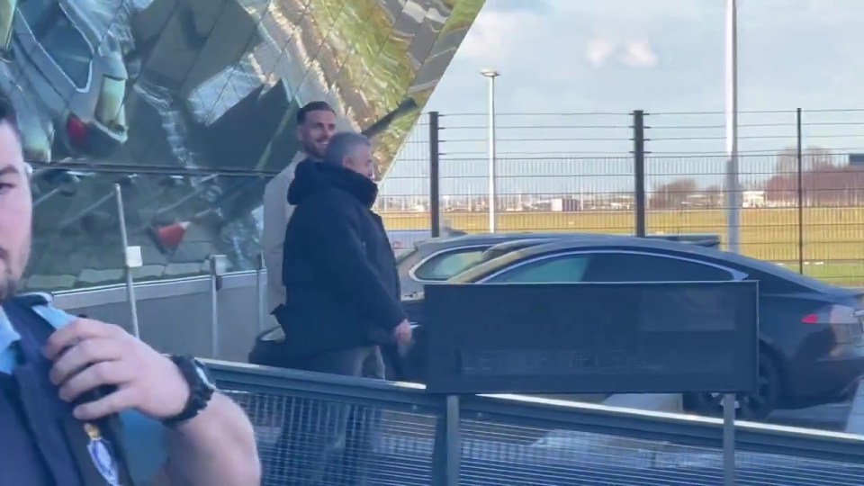 Henderson was seen smiling at the camera as he made his way out of the airport