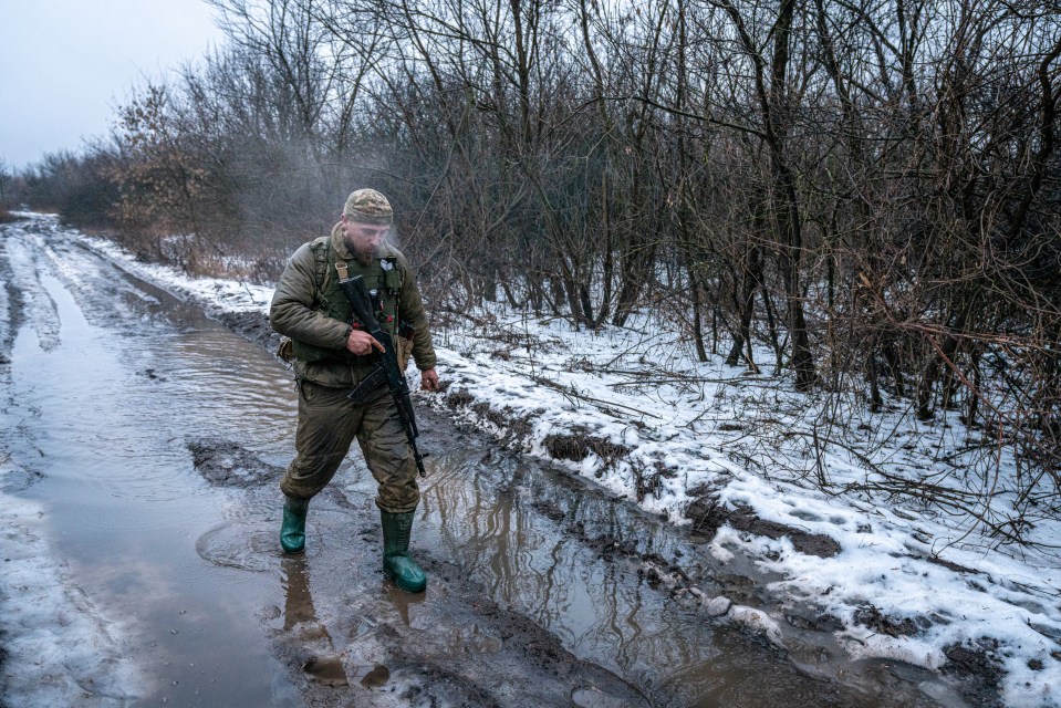 A Ukrainian infantryman walks towards his trench near Bakhmut on January 19