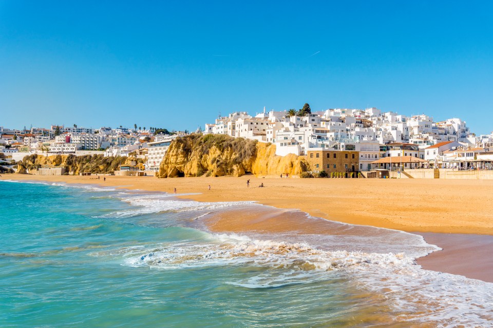 The wide, sandy beach in the white city of Albufeira in the Algarve, Portugal