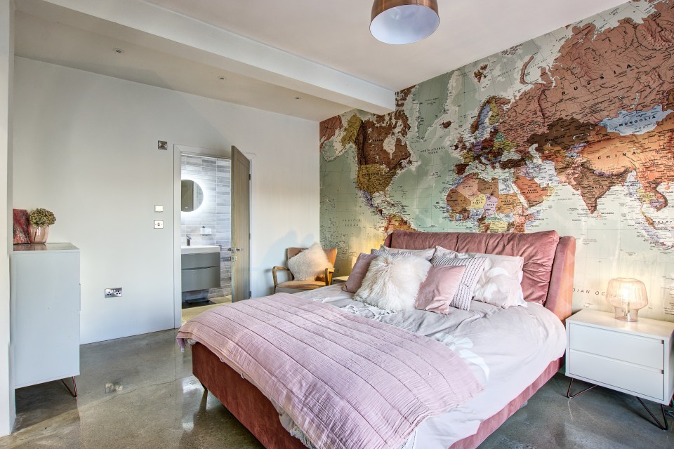 An en-suite master bedroom boasts a feature wall