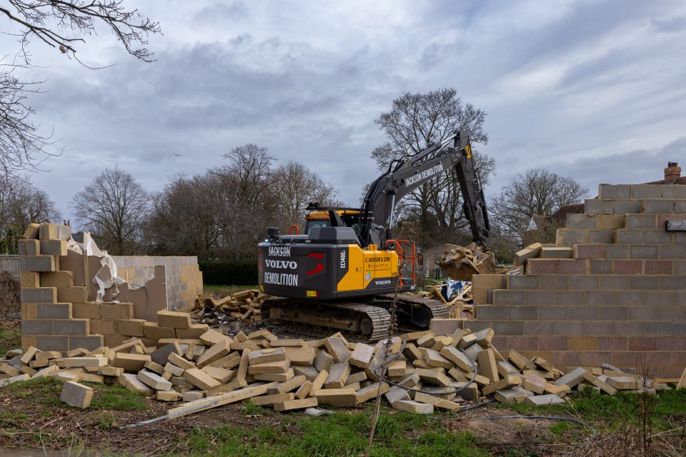 workmen knocking the last wall down at the illegal spa complex this morning