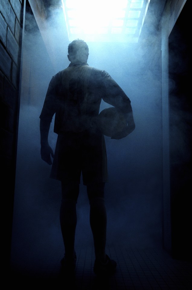 Football player entering steam room, rear view