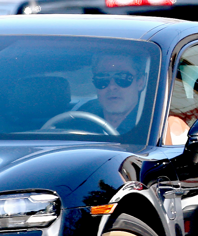 Brad, 60, sported shades as he sat in the driving seat