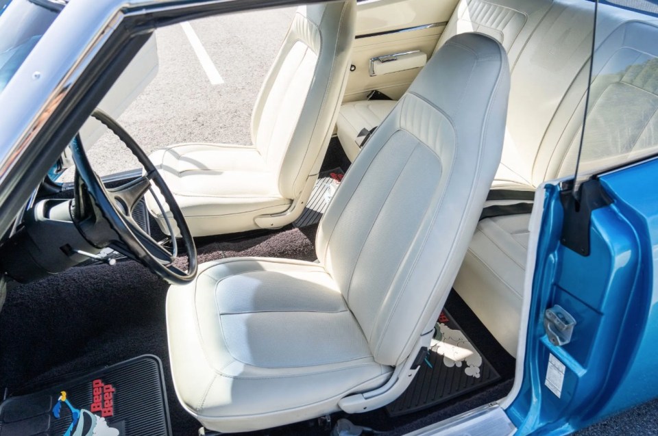 It boasts a classic white vinyl upholstery inside