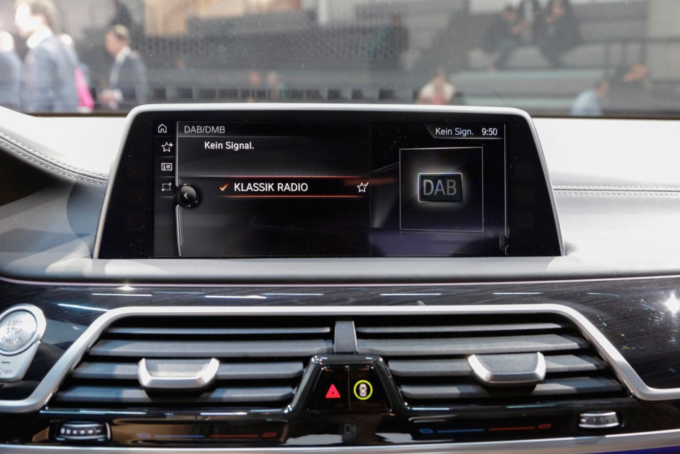 A DAB radio gesture controlled dashboard device sits inside a 7 Series car