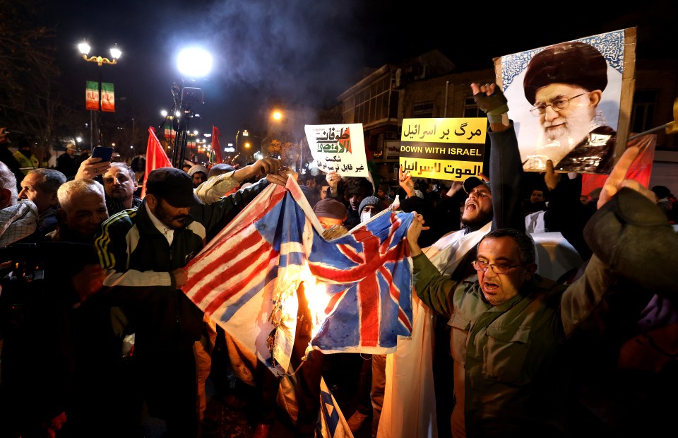 Iranian protesters burning the American and British flags after the countries launched strikes against Houthi rebel targets in Yemen