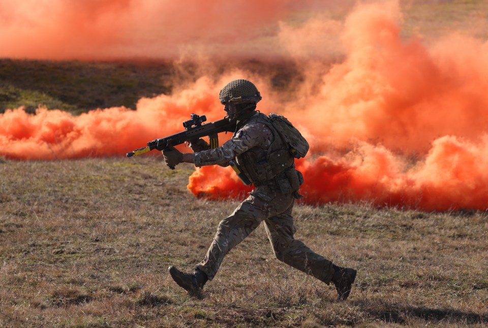 A soldier of the United Kingdom’s 2nd Battalion Royal Anglian infantry unit storms an enemy position in a simulated attack