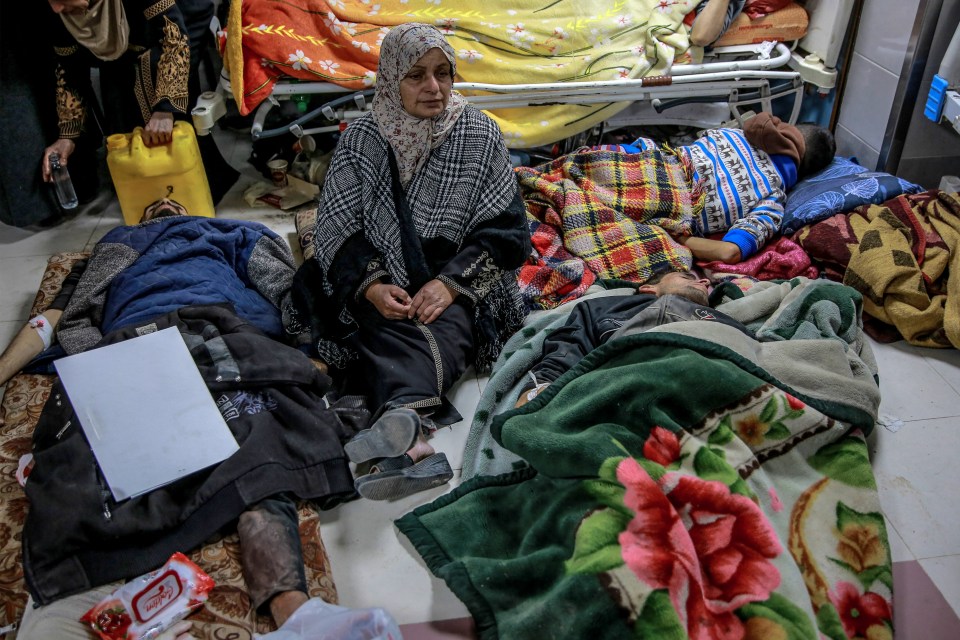 A woman sitting at the incredibly overwhelmed Al-Shifa hospital