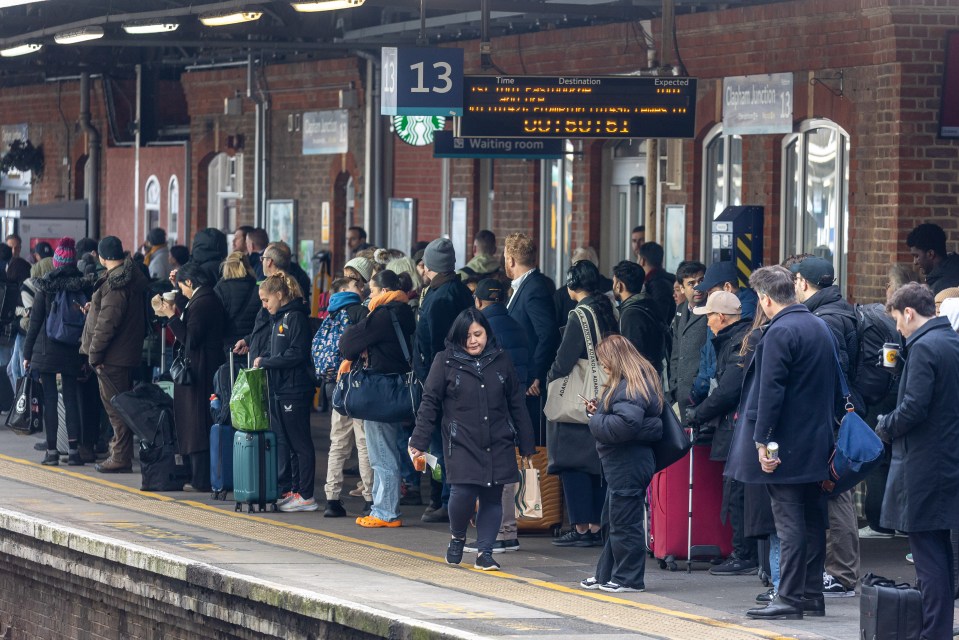 Passengers queued for trains towards Gatwick and Brighton at Clapham Junction, London, this morning