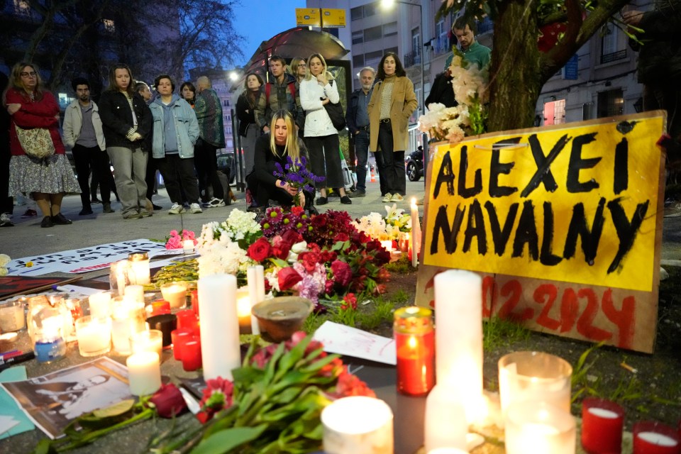 People place candles and flowers in Lisbon