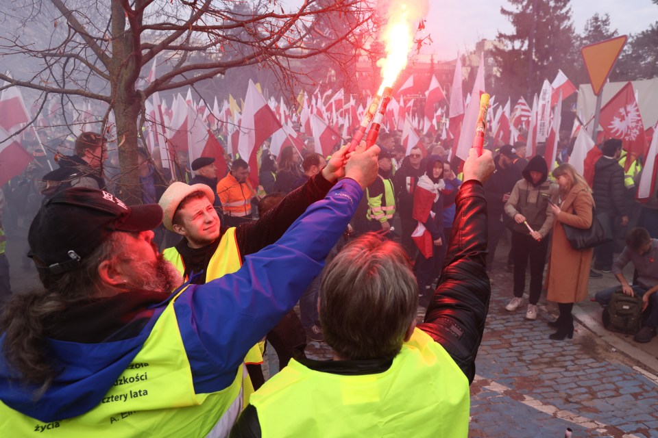 Farmers light flares during a protest in Warsaw, Poland, 27 February 2024