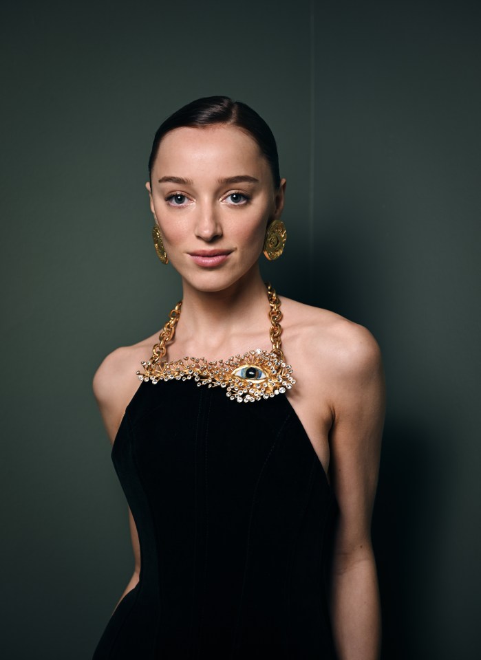 She donned a stylish strapless black dress with gold detailing