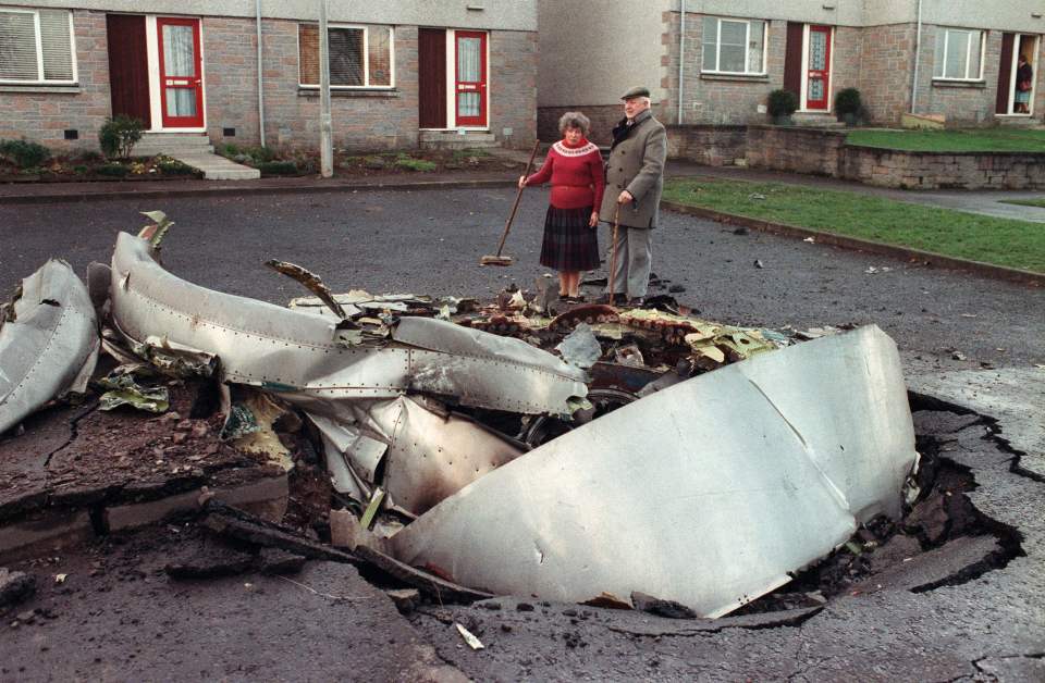 Shocked locals inspect the wreckage of the plane that smashed into the town of Lockerbie