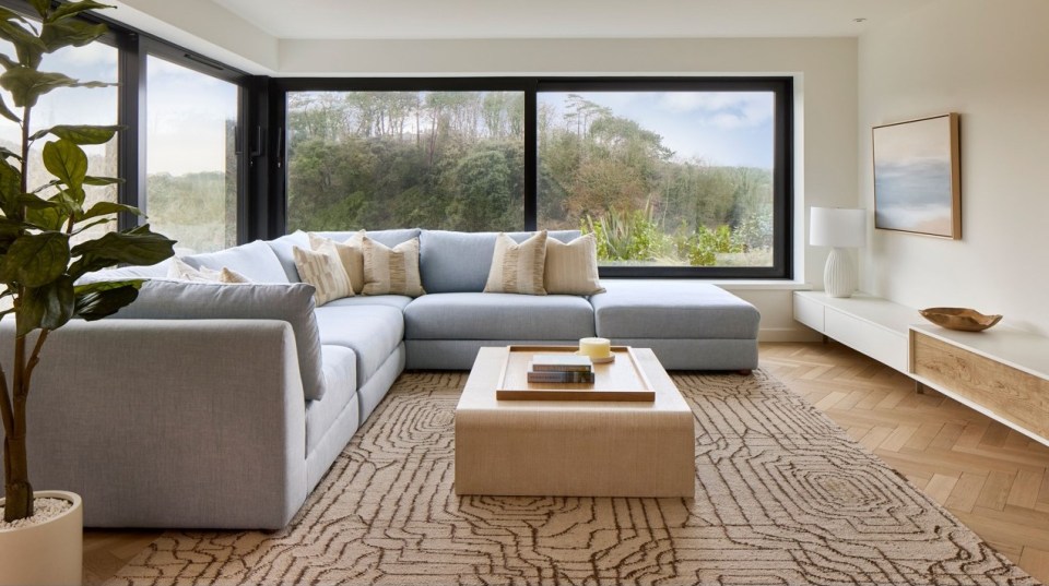 a living room with a sectional couch and a coffee table