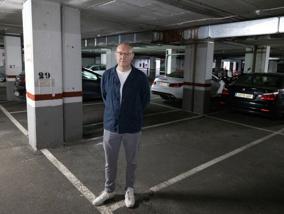 The Sun's Nick Parker stands in murdered Russian pilot Captain Maxim Kuzminov's parking space in the underground car park where his body was found