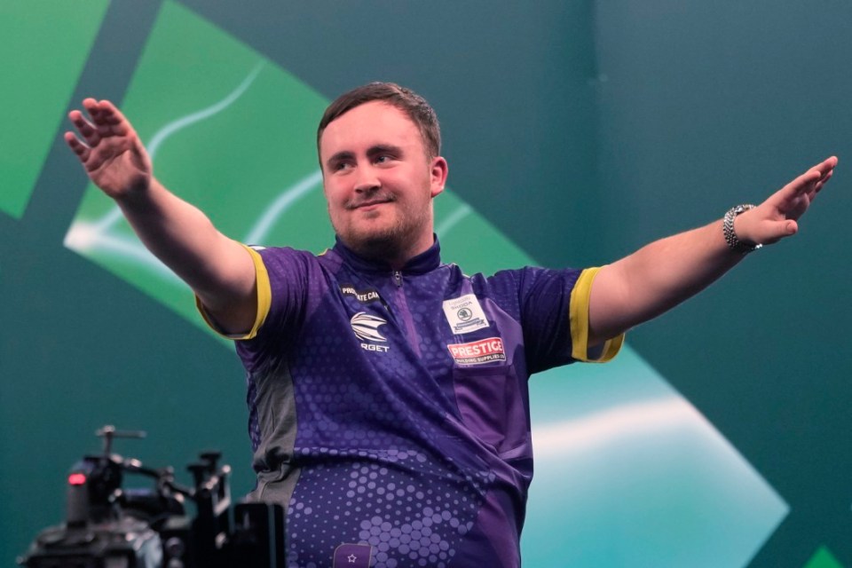 Luke Littler of England celebrates after winning the quarterfinal match against Brendan Dolan of Northern Ireland at the World Darts Championship, in London, Monday, Jan. 1, 2024. (AP Photo/Kin Cheung)