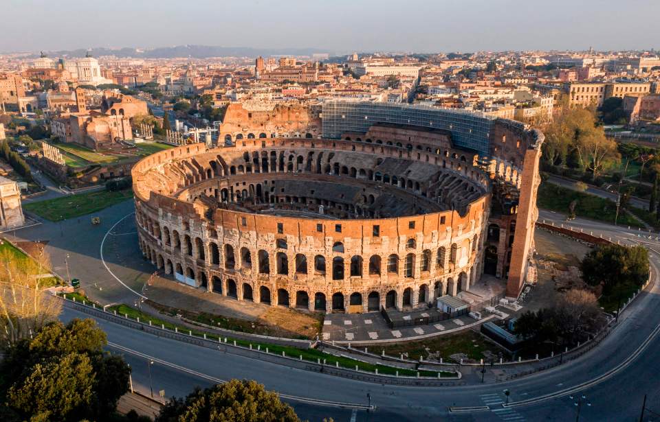 TOPSHOT - A morning aerial photo taken on March 30, 2020 shows deserted streets and the Colosseum monument in Rome during the country's lockdown aimed at curbing the spread of the COVID-19 infection, caused by the novel coronavirus. (Photo by Elio CASTORIA / AFP) / Italy OUT (Photo by ELIO CASTORIA/AFP via Getty Images)