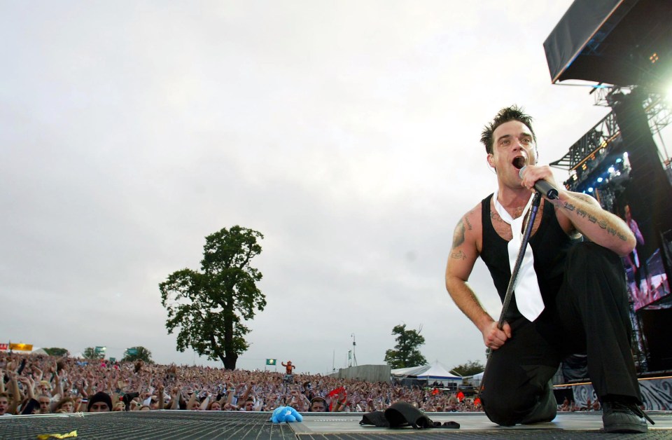 Robbie performs at Knebworth Parth in Hertfordshire in 2003