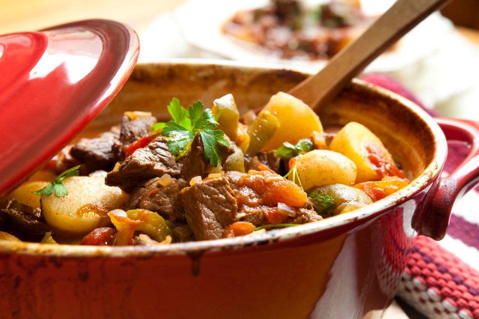 Traditional goulash or beef stew, in red crock pot, ready to serve. Shallow DOF. More beef images: