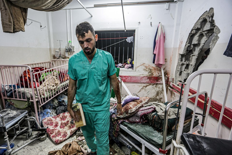 (FILES) A man inspects the damage in a room following Israeli bombardment at Nasser hospital in Khan Yunis in the southern Gaza Strip on December 17, 2023, amid ongoing battles between Israel and the Palestinian militant group Hamas. Medics are sounding the alarm at southern Gaza's Nasser hospital, where a nurse said snipers are killing people, sewage has flooded the emergency room and drinking water has run out. Fighting between Israeli soldiers and Hamas militants has taken place all around Nasser hospital in the southern Gazan city of Khan Yunis. (Photo by STRINGER / AFP) (Photo by STRINGER/AFP via Getty Images)