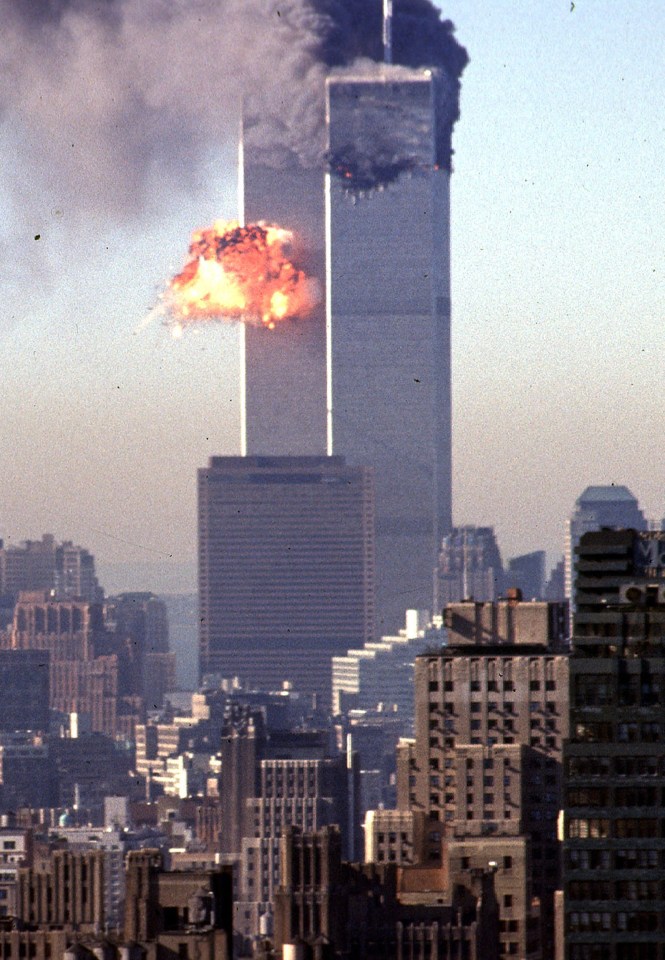 (FILES) In this file photo flames erupt from the north tower of the World Trade Center after commercial aircraft United Airlines flight 175 was deliberately crashed into the building in lower Manhattan, New York on September 11, 2001. - On the morning of September 11, 2001, New Yorkers woke to crisp blue skies following a storm that had soaked America's northeastern seaboard the day before. The cloudless, beautiful sky was little portent of the dark, history-changing day that was to come but would remain etched on the memory of those involved. (Photo by SETH MCALLISTER / AFP) (Photo by SETH MCALLISTER/AFP via Getty Images)