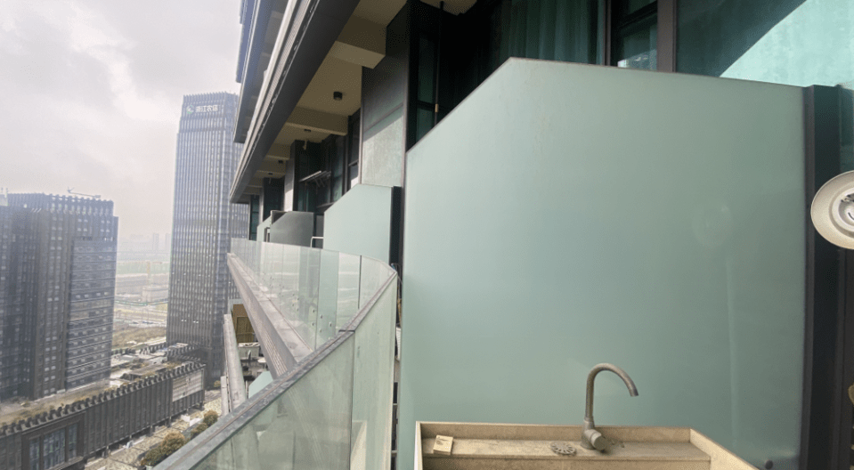 A view from one of the balcony's in the building, featuring an outdoor sink