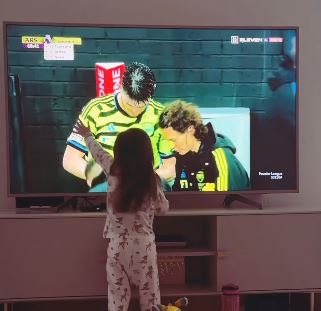 The defender's daughter was filmed hugging the TV when he came on