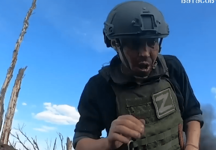 A shocked Russian fighter approaching a Ukrainan troop after he was forced to flee the trench