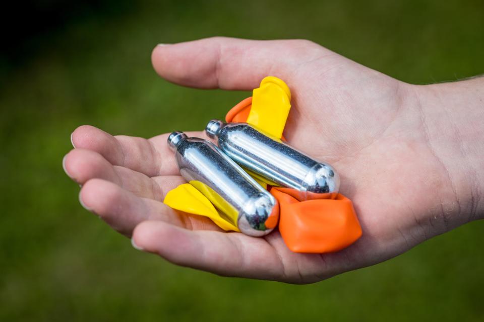 WAFABK A teenager fills a balloon with nitrous oxide (laughing gas) also known as hippy crack