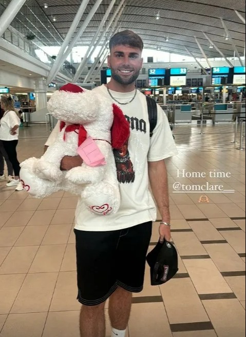 Love Island winner Tom Clare was all smiles at he headed back to the UK