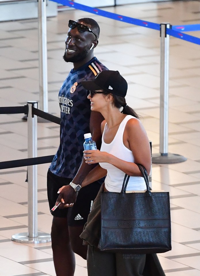 The pair looked loved-up as they held hands through the airport