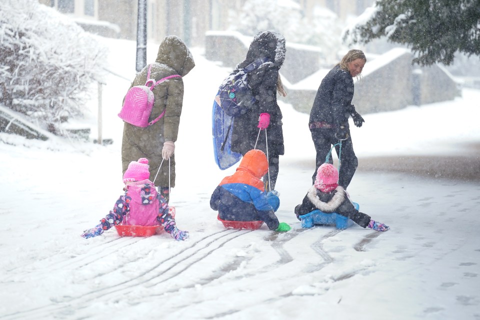 Children were pulled through the snow on sleds in Buxton, Derbyshire, on Thursday