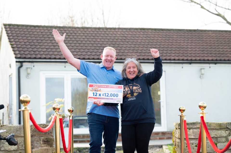 People's Postcode Lottery winners Andy and Meg pose with their winnings