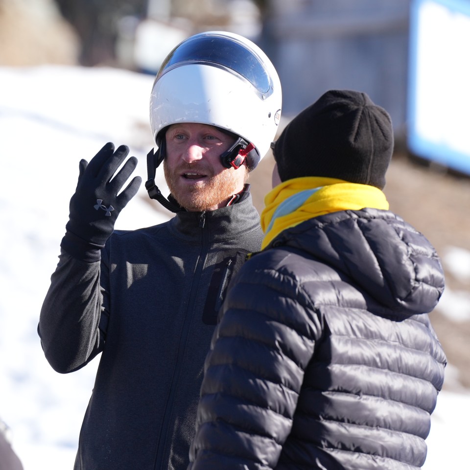 Harry donned a white bobsleigh helmet as he spoke to competitors