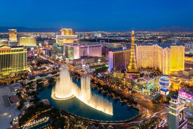 Las Vegas skyline at night, featuring the Bellagio fountains.