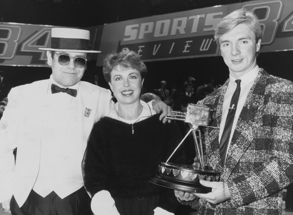 The pair pose with pop star Elton John