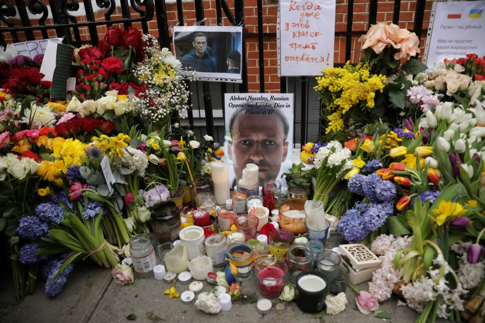 Flowers and candles lay outside the Russian embassy