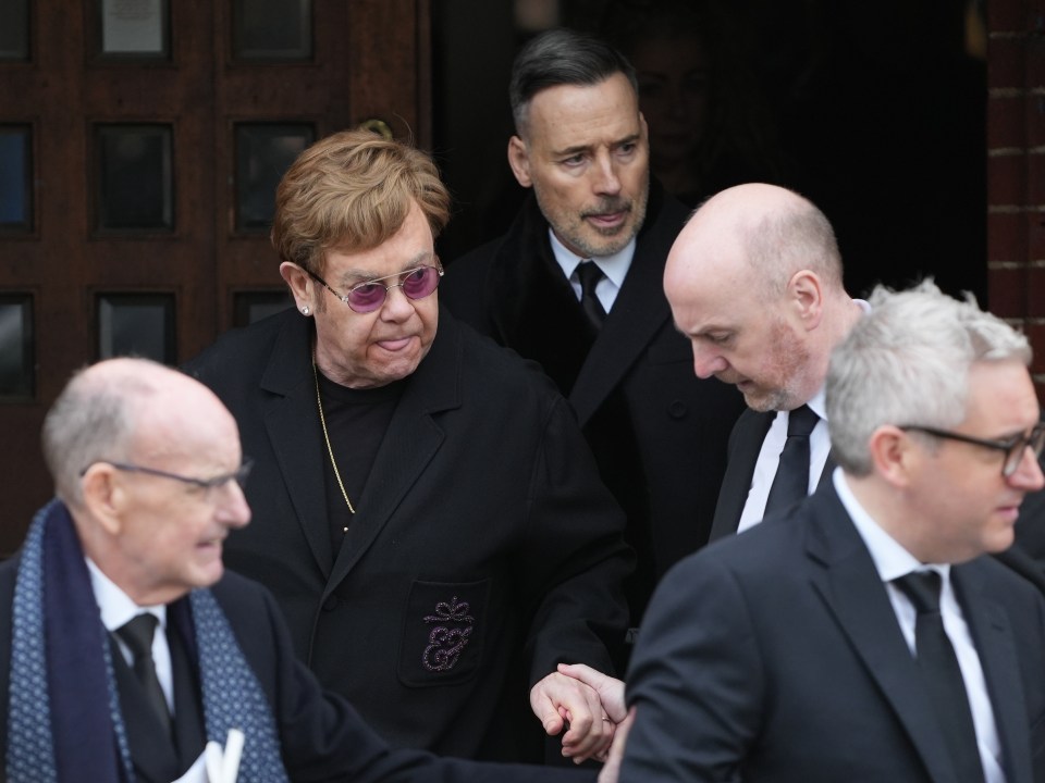 Sir Elton was helped down the stairs at the entrance after the service