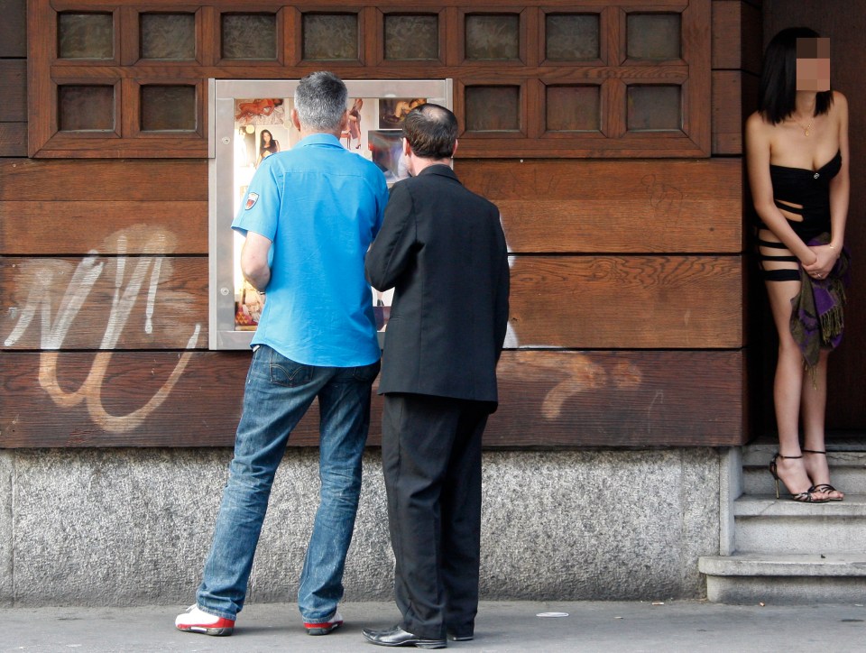 A hostess stands at the entrance of a night-club located next to the famous Langstrasse street in Zurich