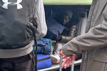 Two migrants were caught hiding in the hold of a school coach returning from a trip to France