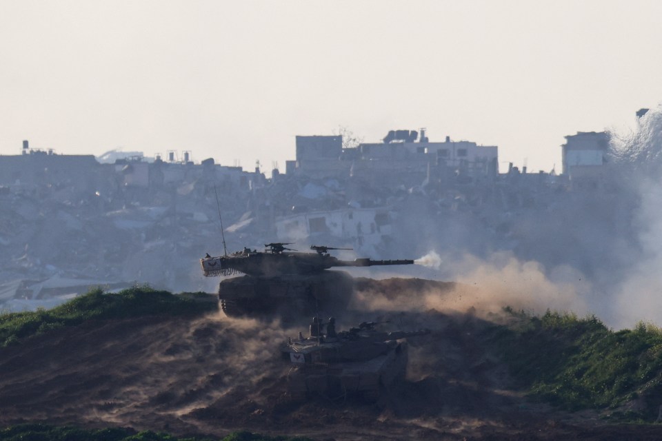 An Israeli tank fires into the Gaza Strip from Israel