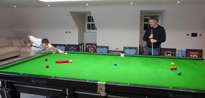 A host of Premier League legends' shirt surround the snooker table