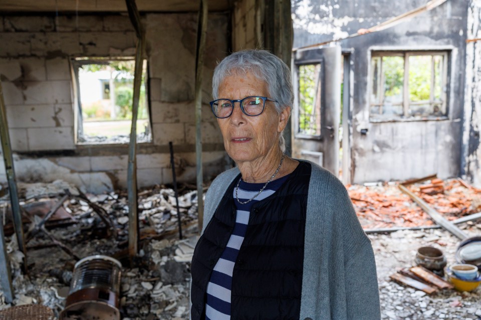 Nili Barsinai in the ruined home of her murdered neighbour after the Hamas massacre