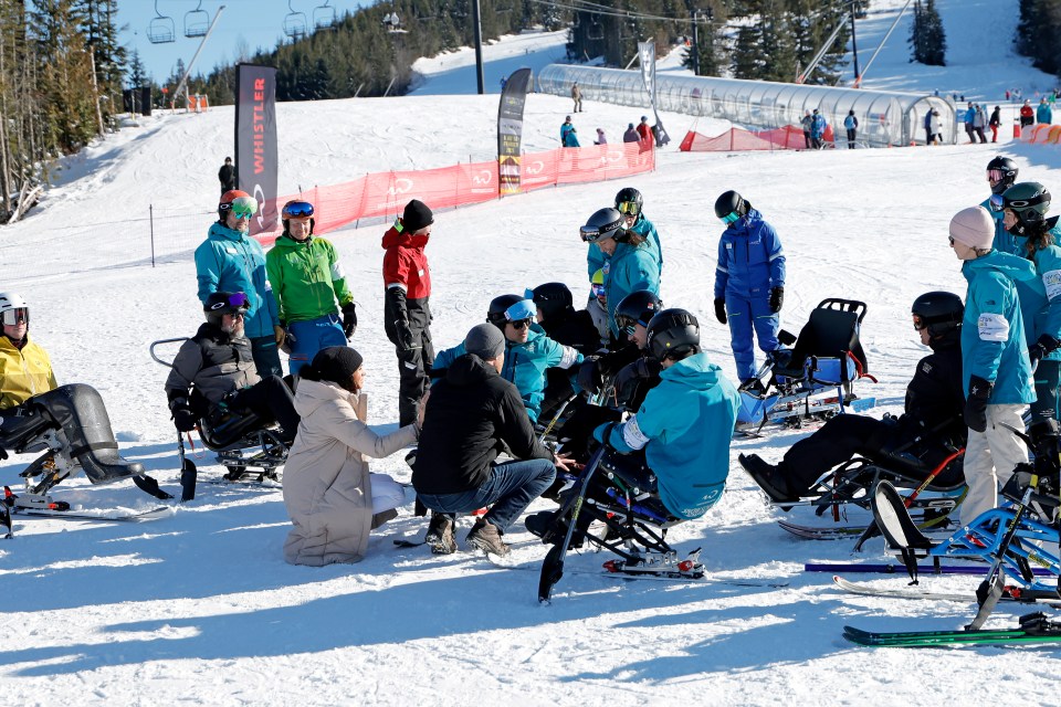 The couple chatted and joked around as they with groups of sit-skiers, standing skiers and visually impaired athletes