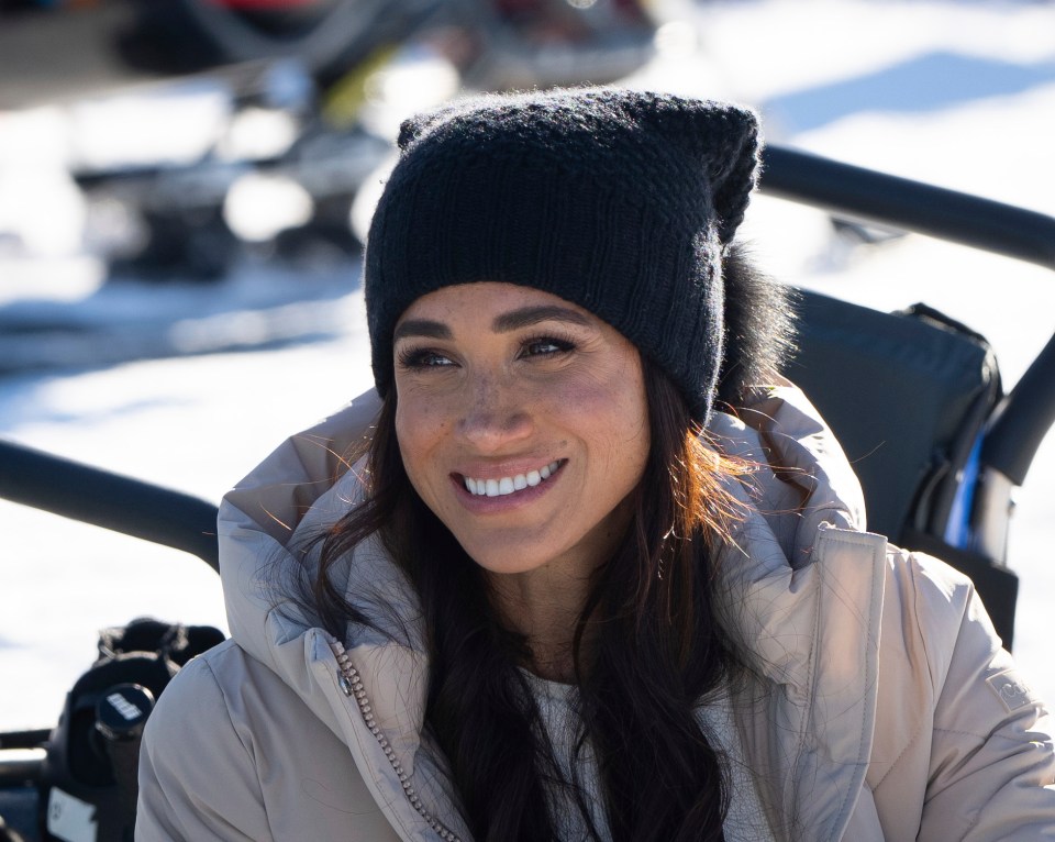 Meghan was dressed for the snow in a hat and warm coat