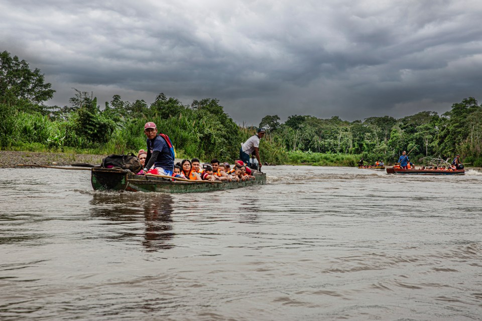 Migrants arrive across the Tuquesa River at the Lajas Blancas Migrant Reception Station, a camp set up by the Panamanian government