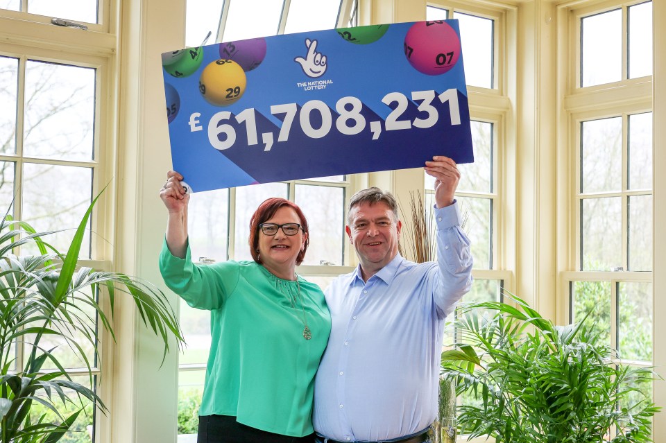 Debbie and Richard holding their £61million lotto cheque